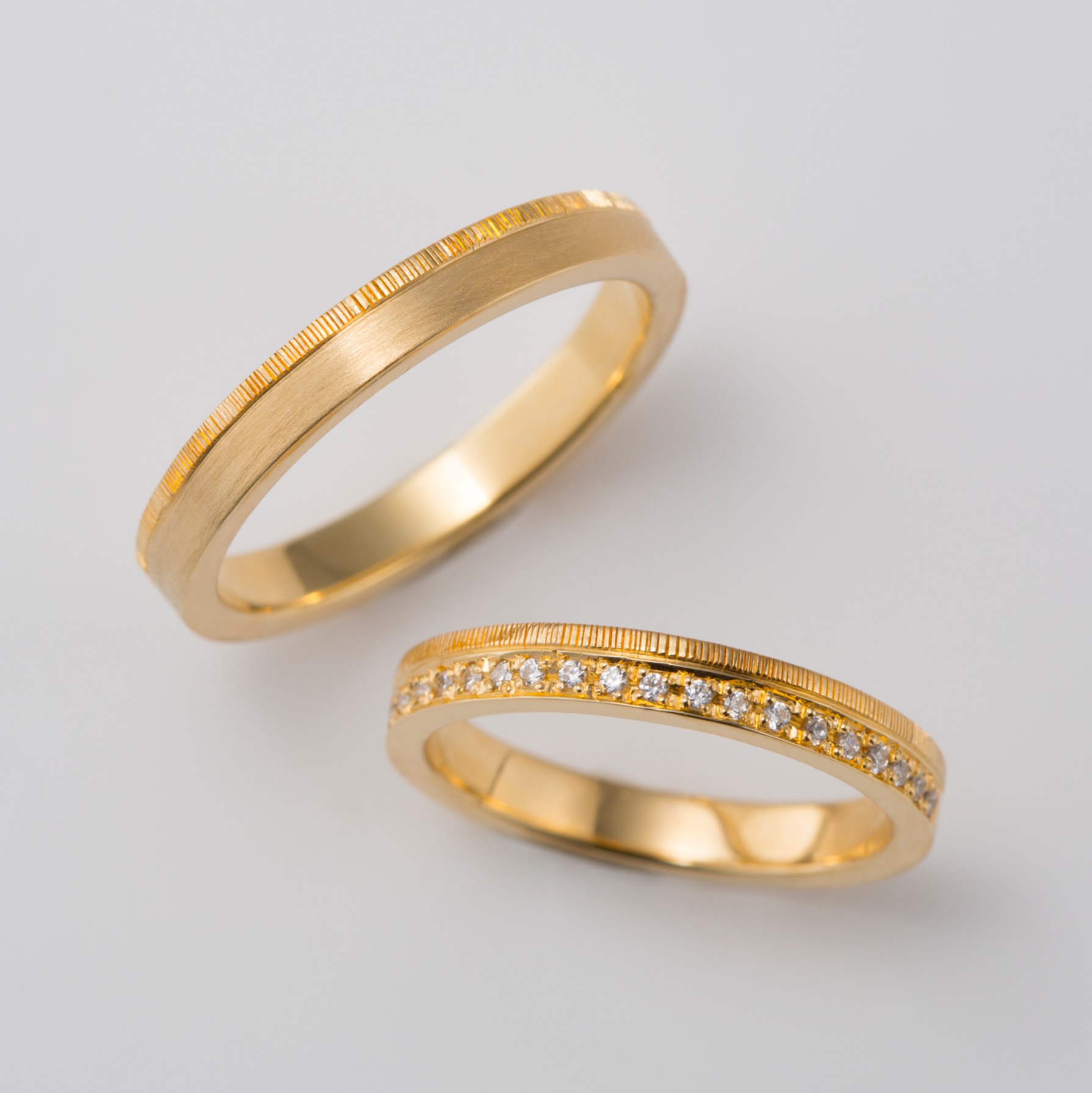 ダイヤモンドをあしらったつや消しゴールドの結婚指輪