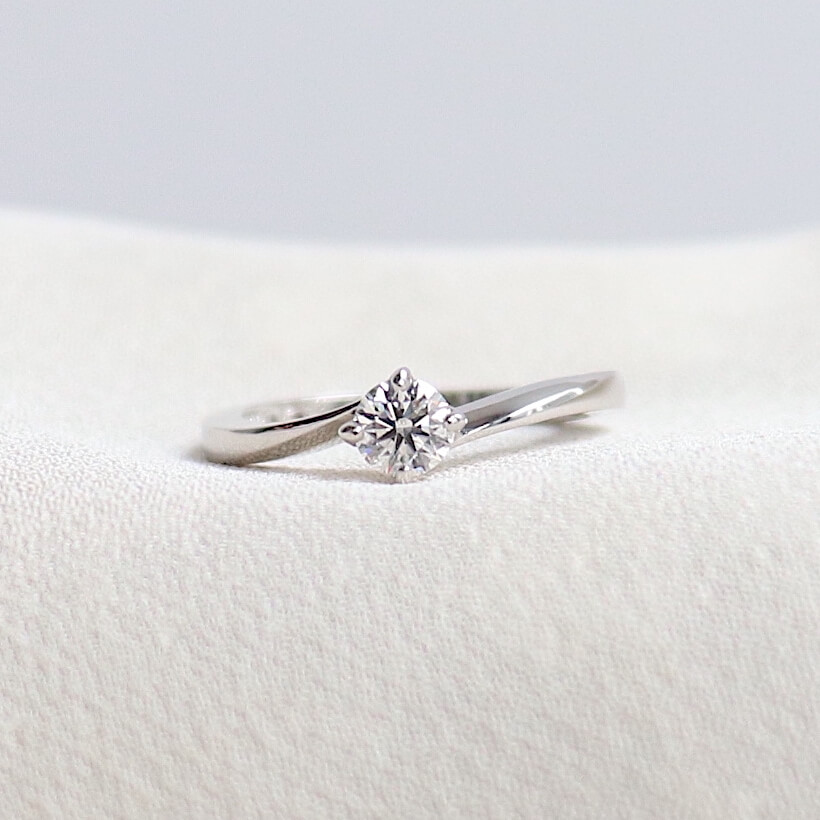ダイヤモンドを包み込むような一体感のあるフォルムの婚約指輪